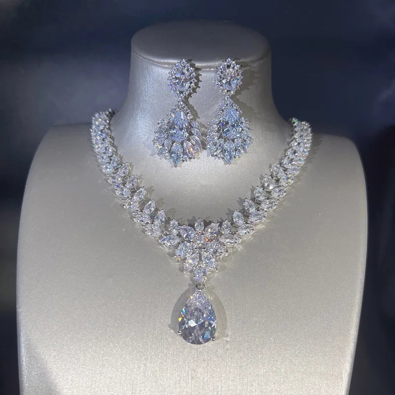 Diamond necklace and earrings set on a mannequin bust against a dark background