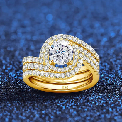 Gold engagement ring set with diamonds on a blue glitter background.

