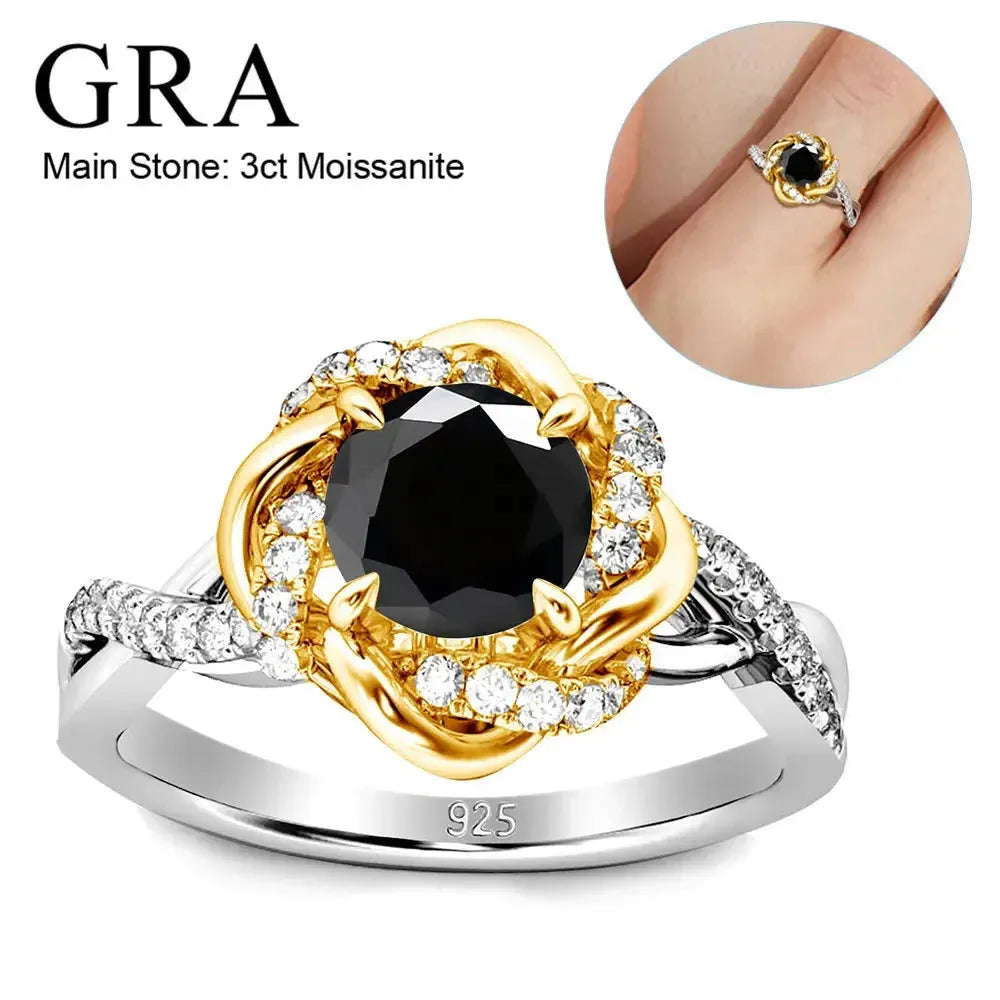 A ring featuring a 3-carat black moissanite as the main stone, surrounded by smaller clear stones. The setting is a mix of gold and silver tones, with a "925" stamp indicating sterling silver. An inset image shows the ring worn on a finger.