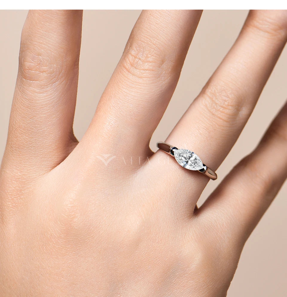 Diamond ring on a hand with a neutral background