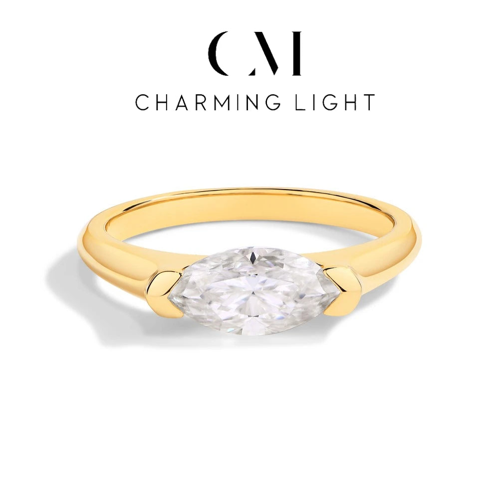 Gold ring with a diamond on a white background, featuring 'Charming Light' branding.