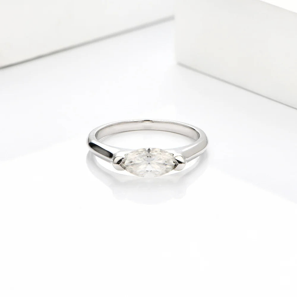 Silver ring with a clear gemstone on a white background