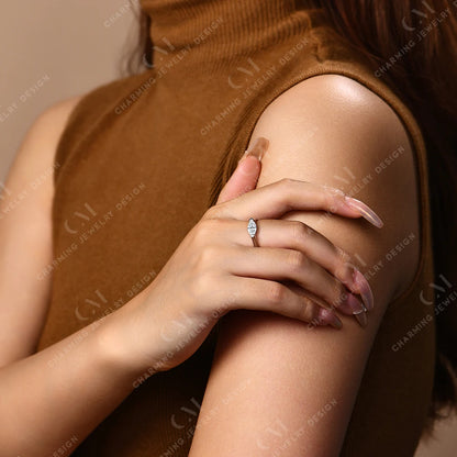 Close-up of a hand wearing a ring on a blurred background