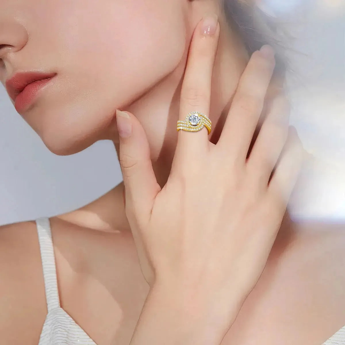 Woman's hand wearing a gold and diamond ring.
