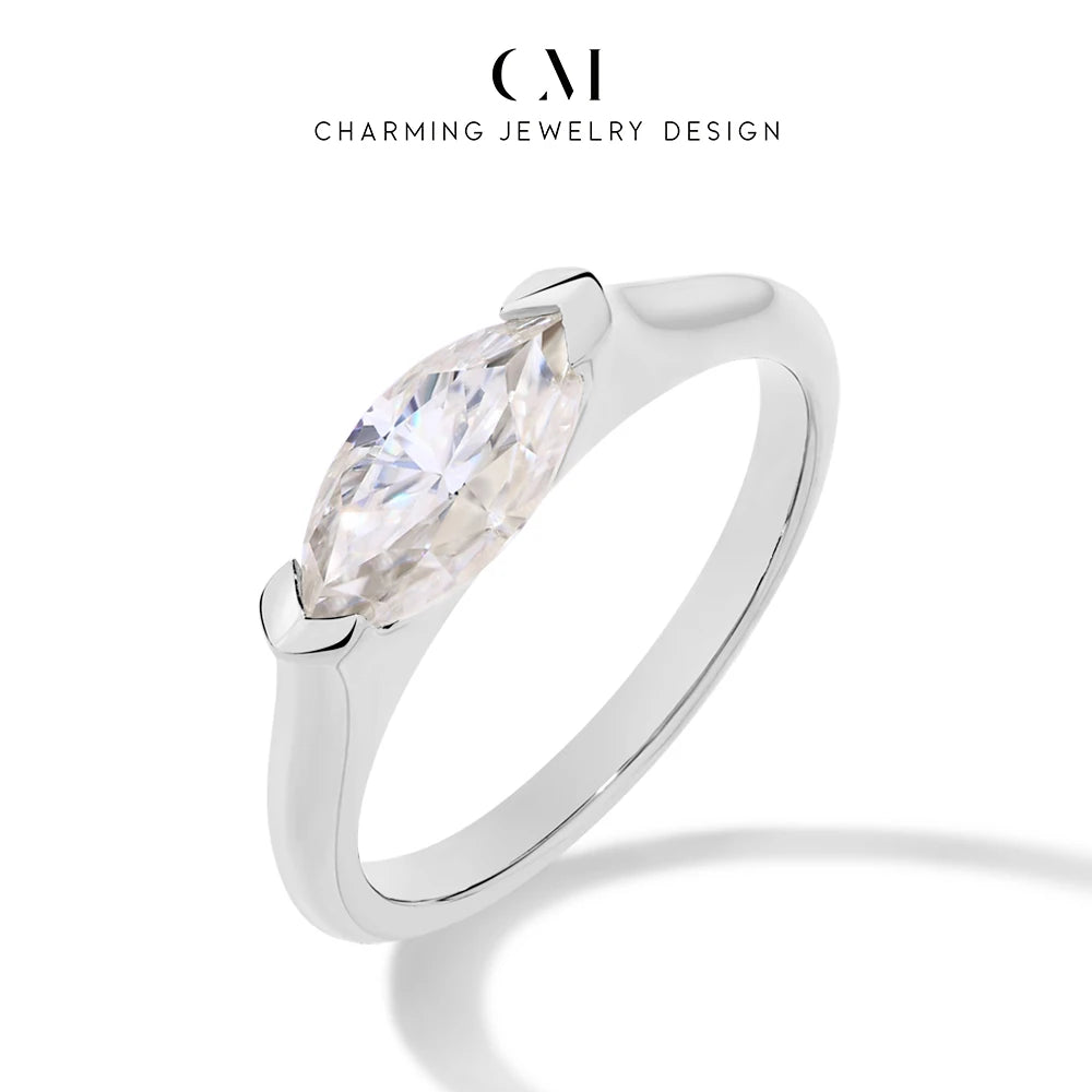 Silver ring with a pear-shaped diamond on a white background, branded 'Charming Jewelry Design'.