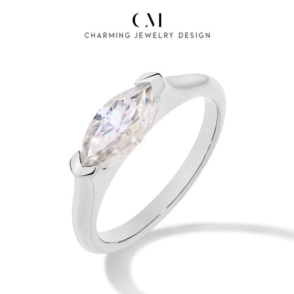 Silver ring with a pear-shaped diamond on a white background, branded 'Charming Jewelry Design'.