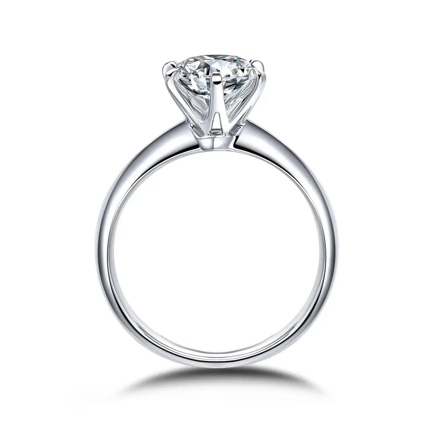 A silver engagement ring with a round diamond set in a classic prong setting.