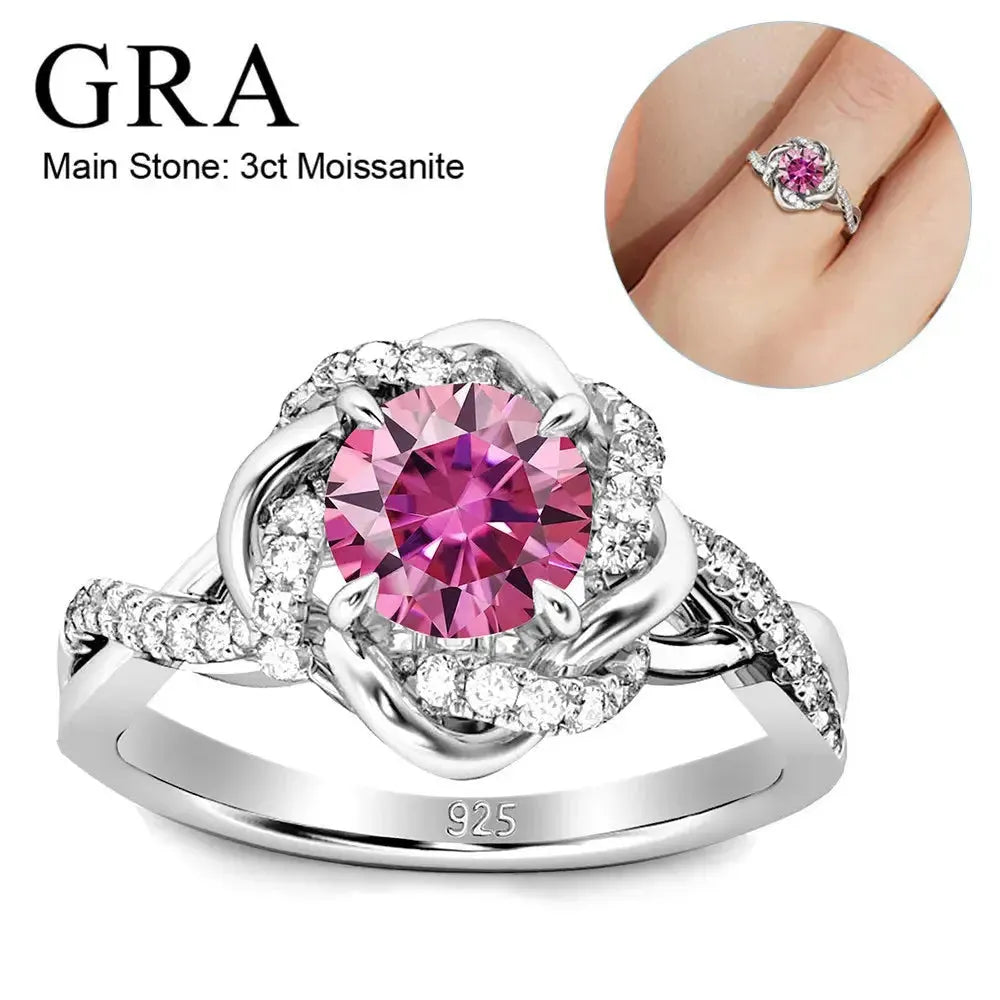 A ring with a pink center stone set in a silver band with small diamonds.